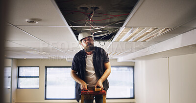 Buy stock photo Electrician, man and light wires for construction, remodeling project or renovation for office. Handyman, contractor repair and power outlet for electric fixture, circuit or system installation