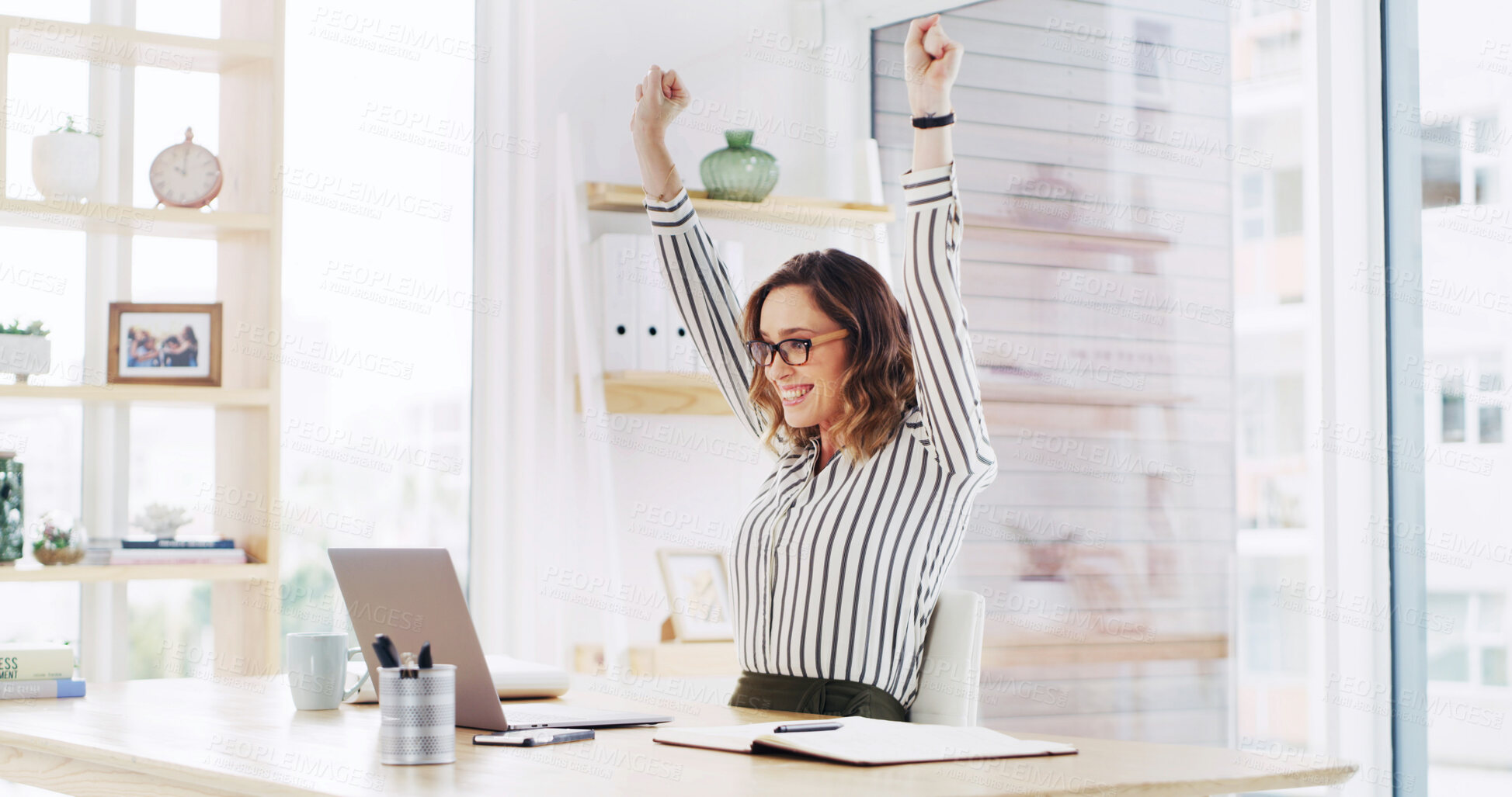 Buy stock photo Cheering, laptop and smile with business woman at desk in office for celebration of goals or target. Computer, hands raised and success with happy employee in workplace for achievement or milestone