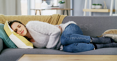 Buy stock photo Sleeping, woman and stomach pain with cramps in lounge, constipation or symptoms of menstrual cycle. Person, discomfort and bloated abdomen in house, endometriosis and tummy ache on couch or resting