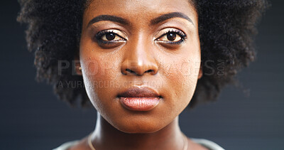 Buy stock photo Serious, black woman and portrait with stare in studio for awareness on a dark background. Face, female person or African model with facial expression, afro or features for empowerment or confidence