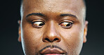 Nervous, anxiety and eyes of black man in studio for stress, fear and paranoid for mental health risk. Horror, terror and nightmare with person with schizophrenia on dark background for danger