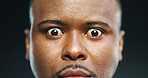 Shock, anxiety and portrait with eyes of black man in studio for stress, fear and paranoid for mental health risk. Horror, terror and nightmare with person with schizophrenia on dark background