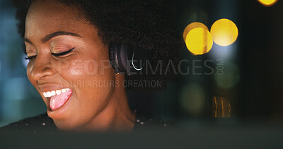 Buy stock photo Woman, headphones and singing at night in office with bokeh, music and computer at media company. African person, happy and inspiration at startup, overtime and audio subscription at creative agency