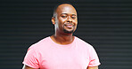 Happy, black man and portrait with fashion in studio for style or awareness on a dark background. Face, African model or smile with pink tshirt for clothing, confidence or pride on mockup space