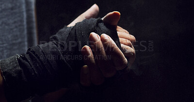 Buy stock photo Fitness, hand and person in closeup with wrap, skin protection and preparation for MMA. Combat, training and athlete in studio with textile bandage, match safety and warm up on dark background.