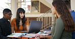 Laptop, group and students in library with studying for college exam, test or assignment together. Computer, happy and people with education for assessment with teamwork at university campus.