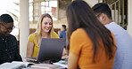 Laptop, happy and people in library with studying for college exam, test or assignment together. Computer, group and students with education for assessment with teamwork at university campus.