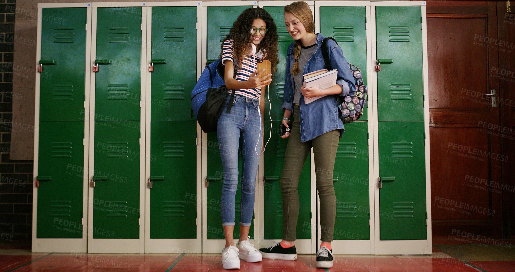 Buy stock photo High school, friends and students with cellphone, smile and funny meme with education, locker and joke. Below, people and girls with smartphone, social media and happiness with message to contact
