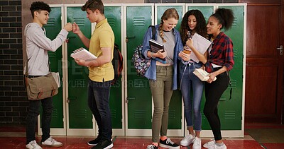 Buy stock photo Teenagers, group and people at high school for story, gossip or learning at recess. Education, happy friends or students in conversation on break by lockers with fist bump, chat and laugh at campus
