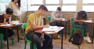 Buy stock photo Exam, high school and teacher walking in classroom for assessment, test and quiz supervision. Teaching, academy and woman with students writing assignment for education, learning and lesson progress