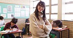Happy woman, teacher and portrait with students in school for learning or education development. Female person, educator or academic instructor with smile, arms crossed or confidence in classroom