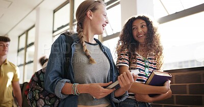 Buy stock photo Talking, friends and girls in hallway at high school for learning, lesson and education together. Happy, campus and teenagers in corridor with books for morning class with chat, conversation or break