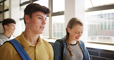 Buy stock photo Boy, girl and talk in hallway at high school with smile, development and chat on walk to class. Friends, teenager and happy for education, conversation and listen with scholarship at academy