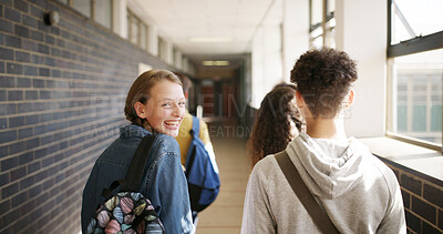 Buy stock photo Happy people, students and walking with back in school hallway for class schedule on campus. Portrait, friends or teenager with group, bag or smile for education, learning or development in corridor
