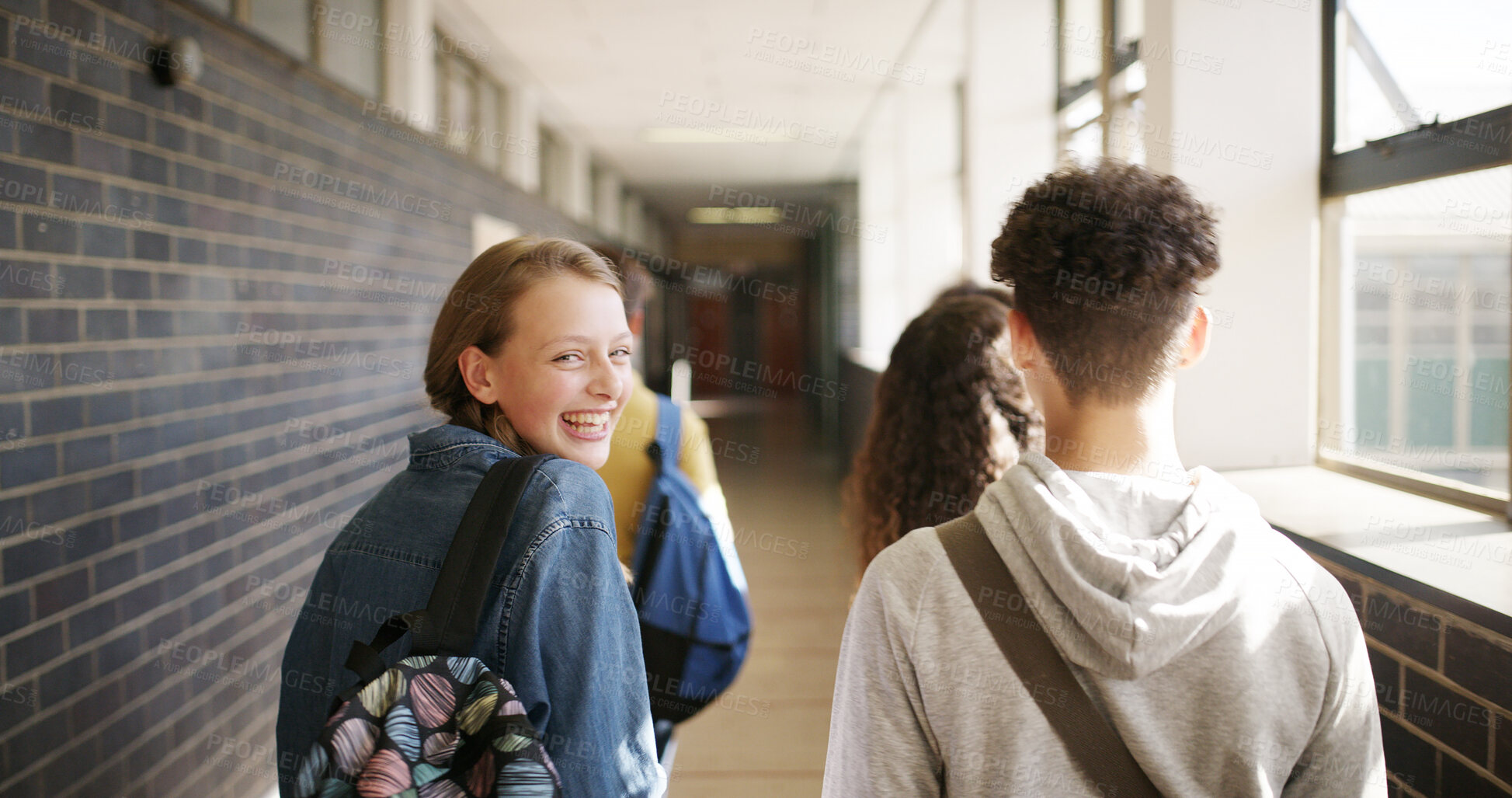 Buy stock photo Happy people, students and walking with back in school hallway for class schedule on campus. Portrait, friends or teenager with group, bag or smile for education, learning or development in corridor