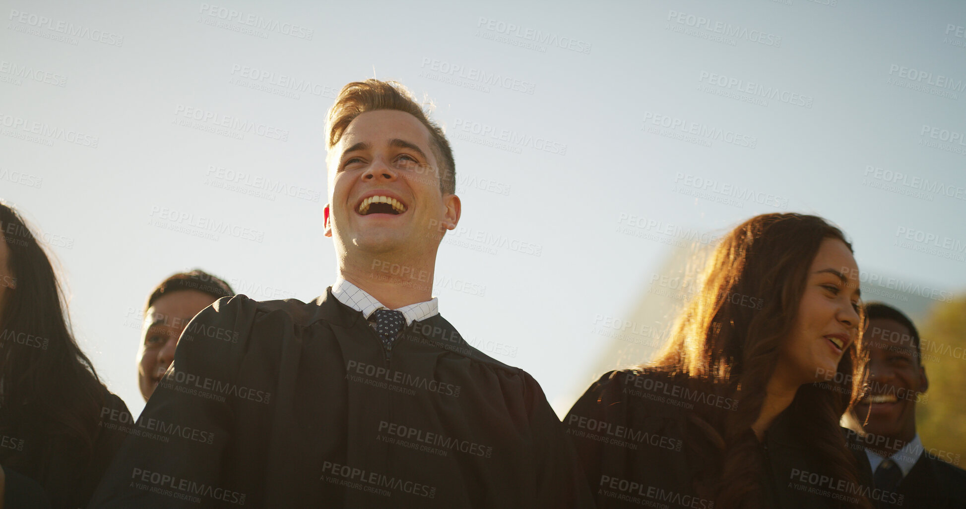 Buy stock photo Smile, man and students and graduation outdoor for education, celebration and class success. Below, people and waiting for diploma of college achievement, award announcement and certificate ceremony