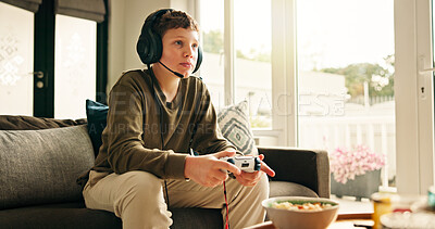 Buy stock photo Snack, video game and boy with controller, kid and subscription with challenge. Home, headset or child on sofa, online contest or audio with esports, gamer or relax with hobby, click or entertainment