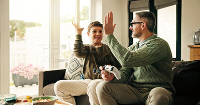 Buy stock photo Father, child and high five for video game in home, win competition or parent bonding with son. Console, happy kid and dad with hands together for success, teamwork and family celebration in lounge