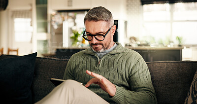 Buy stock photo Tablet, remote work and mature man in home to review news, article or report online. Technology, journalist and freelancer in living room to check email for headline, story and research on internet