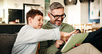 Home, father and son on couch, tablet and bonding together with online game, support and smile. Happy family,  network and dad on sofa, boy and parent with tech, social media or digital app with help