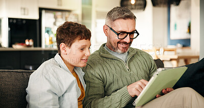 Buy stock photo Home, father and son with tablet, smile and bonding together with online game, relax and support. Entertainment, family and dad on sofa, boy and parent with tech, social media and app with connection