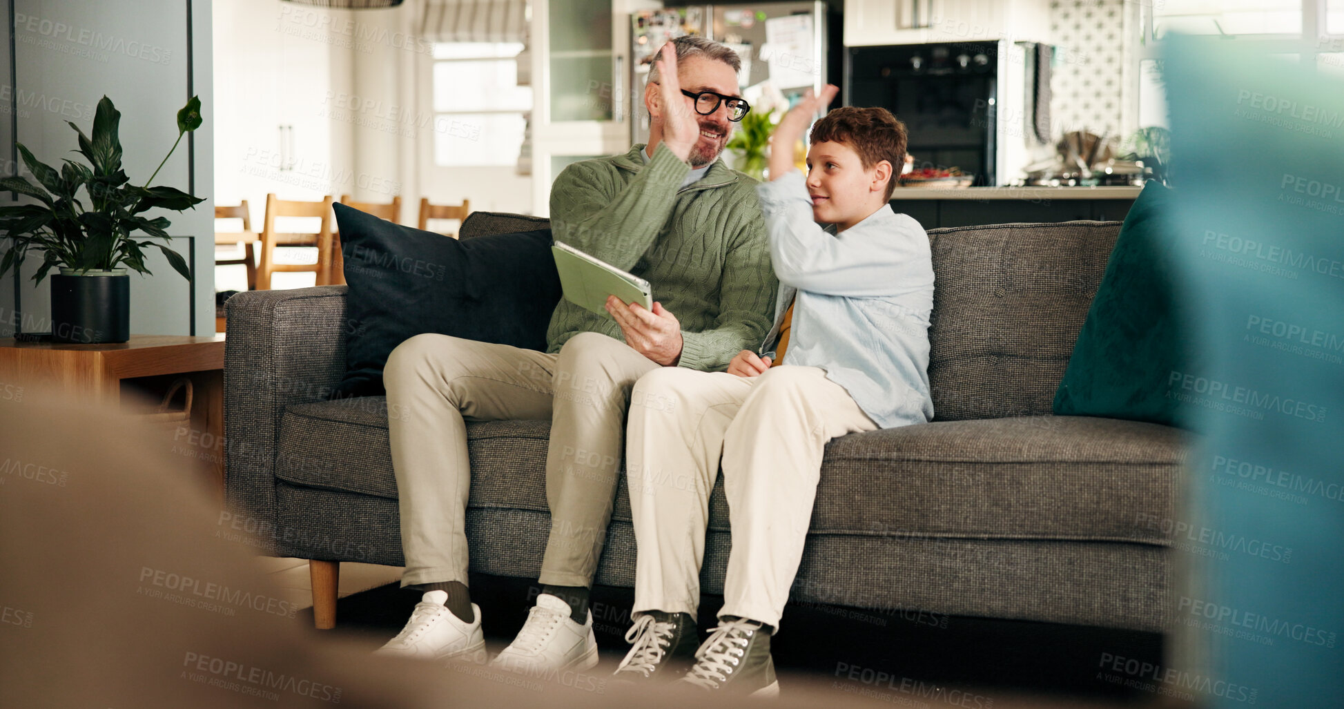 Buy stock photo High five, child and dad with tablet, home and bonding in living room, success and education on web. Happy, student and man with tech for elearning, achievement and knowledge on website in house