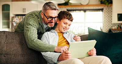 Buy stock photo Tablet, smile and help with father and son on sofa for learning app, education game and bonding. Growth, online school schedule and support with man and kid in family home for reading and streaming