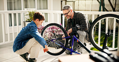 Buy stock photo Father, child and fixing bicycle for learning, help and laugh with son at family home. Dad, kid and bike maintenance together for wheel repair, teaching and cycling hobby at patio with happy parent