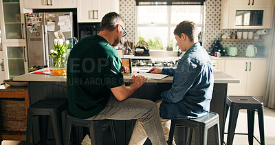 Buy stock photo Home, dad and child with notebook, education and help with math exam, growth or development for boy. Learning, student and man with kid in kitchen, family and preparing for test, knowledge and advice