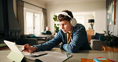 Buy stock photo Homework, tablet and boy with headphones, education and elearning with book, calculator and maths. Apartment, technology and knowledge with online course, notes and studying with audio for test