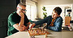 Playing, thinking and father with child for chess in home for learning, development or bonding. Teaching, competition and dad with boy kid for board game with checkmate for problem solving skills.