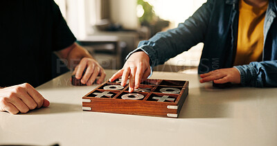 Buy stock photo Board game, development and hands of child with parent in home together, playing tic tac toe. Fun, strategy or thinking with father and son in apartment for noughts and crosses competition or contest