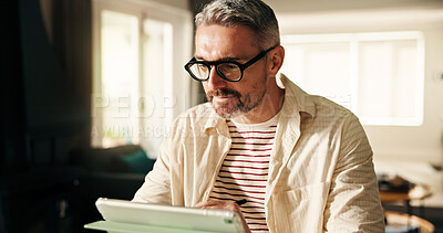 Buy stock photo Tablet, remote work and mature man reading news, review article or report online. Technology, journalist and freelancer in home to check email for headline, story and research with stylus on internet