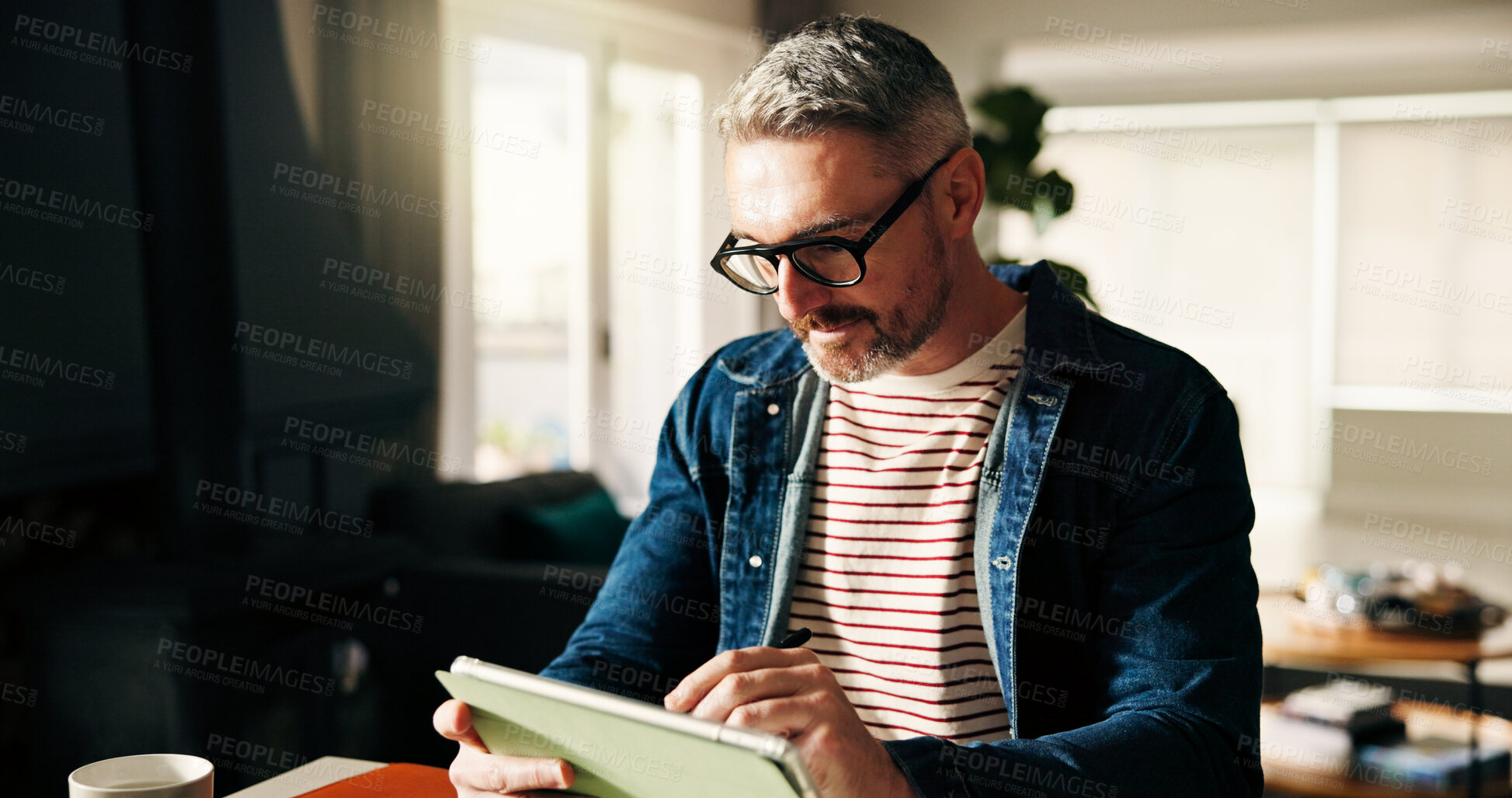 Buy stock photo Business, man or tablet with reading in home office for article review, remote work or blog research. Freelance writer, mature person or technology at desk for publishing revision or planning chapter