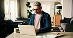 Man, remote work and typing on laptop at house for accounting, finance report and budget stats. Mature person, pc or graph document for financial growth, profit increase and information on investment