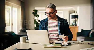 Buy stock photo Laptop, receipt and man in home for finance, calculate budget and savings to review expenses. Computer, paper and mature person with bills for payment, bank fee and check account for debt with taxes