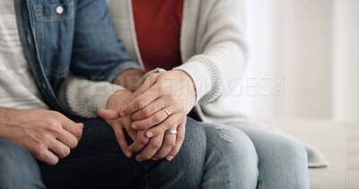 Buy stock photo Holding hands, home and couple on sofa, love and bonding together with care, support and relationship. Apartment, man and woman with marriage, comfort and kindness with romance, relax and trust