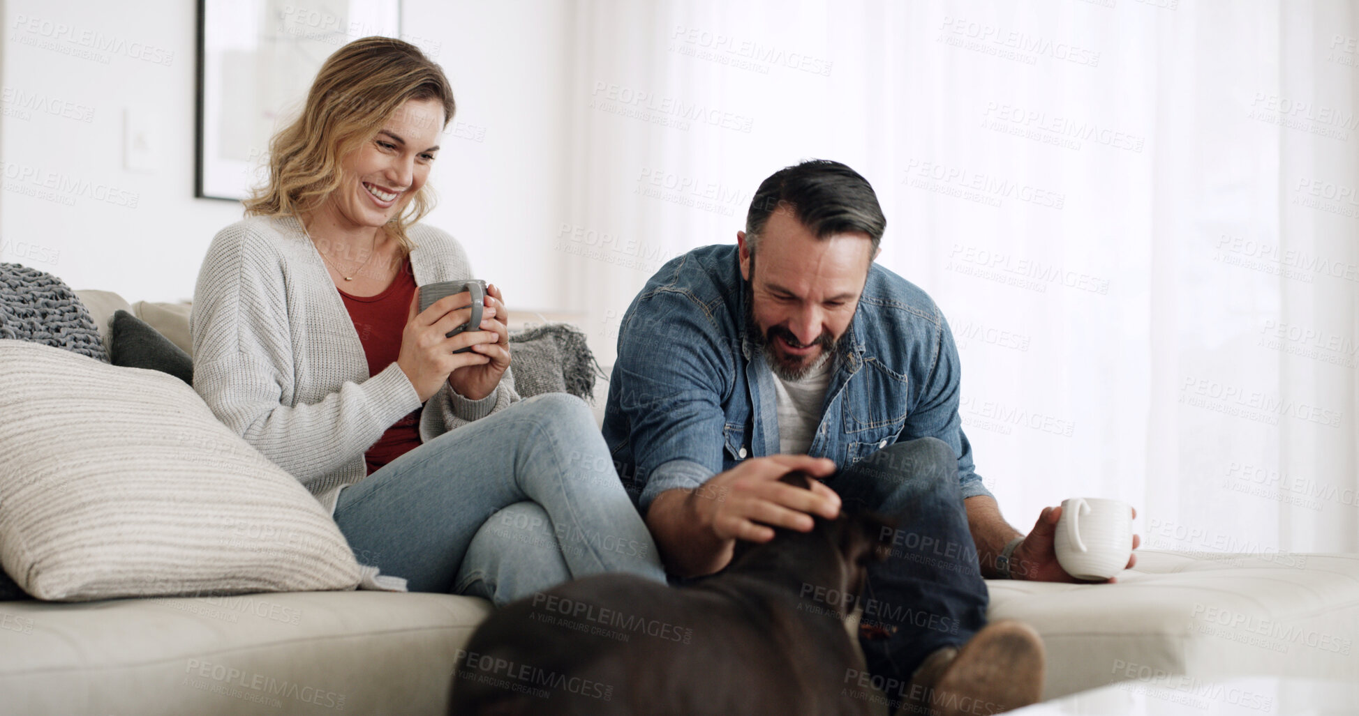 Buy stock photo Home, dog and couple on sofa, love and bonding together with coffee, relax and relationship. Apartment, pet owner and man with woman, canine and comfort with domestic animal, best friend and smile