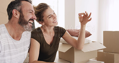 Buy stock photo Boxes, couple and excited with key in new home for moving in, purchase success and achievement. Property relocation, mature man and woman with ownership of house for mortgage investment and security