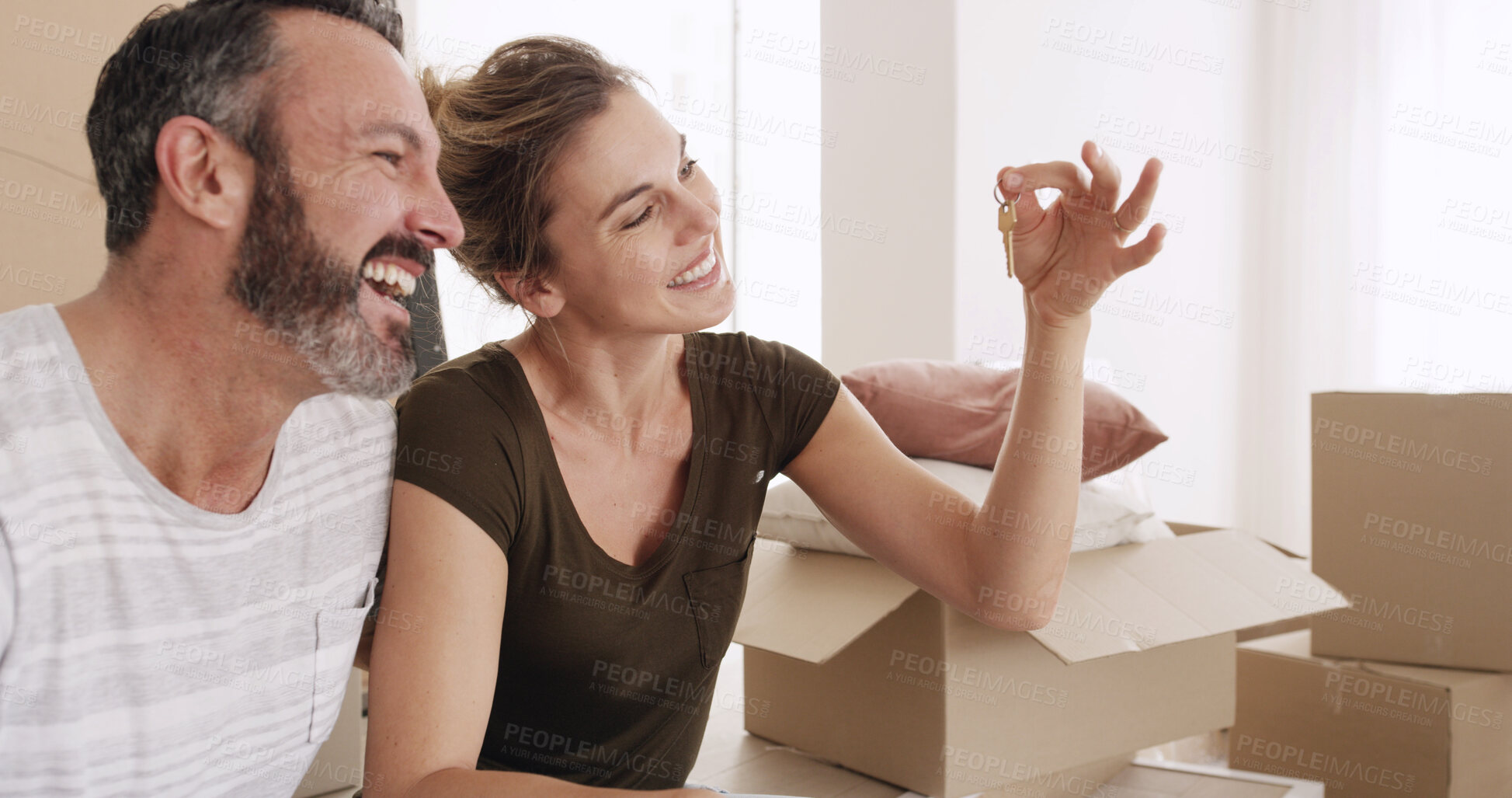Buy stock photo Boxes, couple and excited with key in new home for moving in, purchase success and achievement. Property relocation, mature man and woman with ownership of house for mortgage investment and security