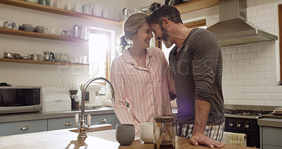 Buy stock photo Coffee, smile and bonding with couple in kitchen for love, commitment and beverage mug. Happiness, support and drink with man and woman in home for connection, marriage and morning break together