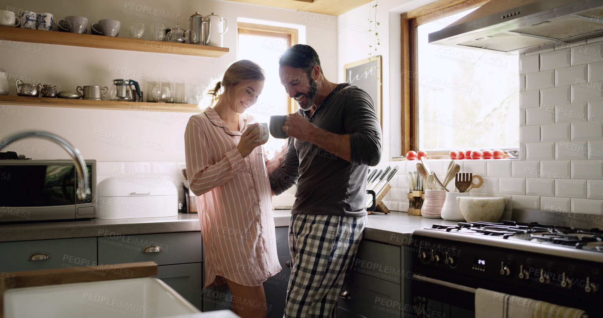 Buy stock photo Cheers, smile and couple with coffee in kitchen for bonding, connection or conversation together. Toast, drinking and man with woman for morning, caffeine beverage and communication or chat in home