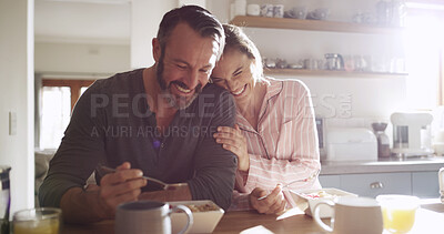 Buy stock photo Happy couple, laugh and eating breakfast in kitchen for health, nutrition and diet with partner. Funny, hungry man and woman with morning meal, cereal and enjoy food with embrace for love in home