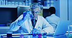 Laboratory, man and scientist with beaker for test, chemical research or experiment with blue light. Chemistry, science and mature medical worker with liquid, inspection or pharmaceutical development