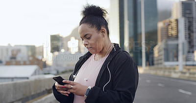Buy stock photo Plus size woman, phone and fitness in city with texting, planning route or break for exercise on bridge. Person, runner and smartphone with app for training stats, routine and weight loss in Brazil