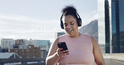 Buy stock photo Phone, fitness and woman with headphones in city to listen to music, audio and workout playlist. Town, runner and happy person on smartphone for health app, exercise or radio for training outdoor