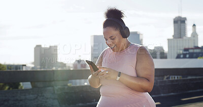 Buy stock photo Plus size woman, headphones and fitness in city with phone, smile and listen to music on bridge. Person, smartphone and training in town for weight loss, happy or streaming app with audio in Brazil