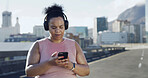 Headphones, fitness and plus size woman with phone in city for audio, podcast or playlist. Sports, mobile and African runner outdoor with radio, streaming online and listening to exercise music
