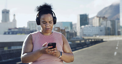 Buy stock photo Headphones, fitness and plus size woman with phone in city for audio, podcast or playlist. Sports, mobile and African runner outdoor with radio, streaming online and listening to exercise music