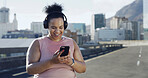Music, exercise and plus size woman with phone in city for audio, podcast or playlist. Sports, mobile and happy African runner with radio, streaming online and listening to headphones for fitness